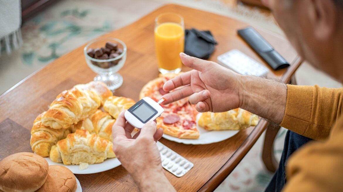 Man checking blood sugar before eating