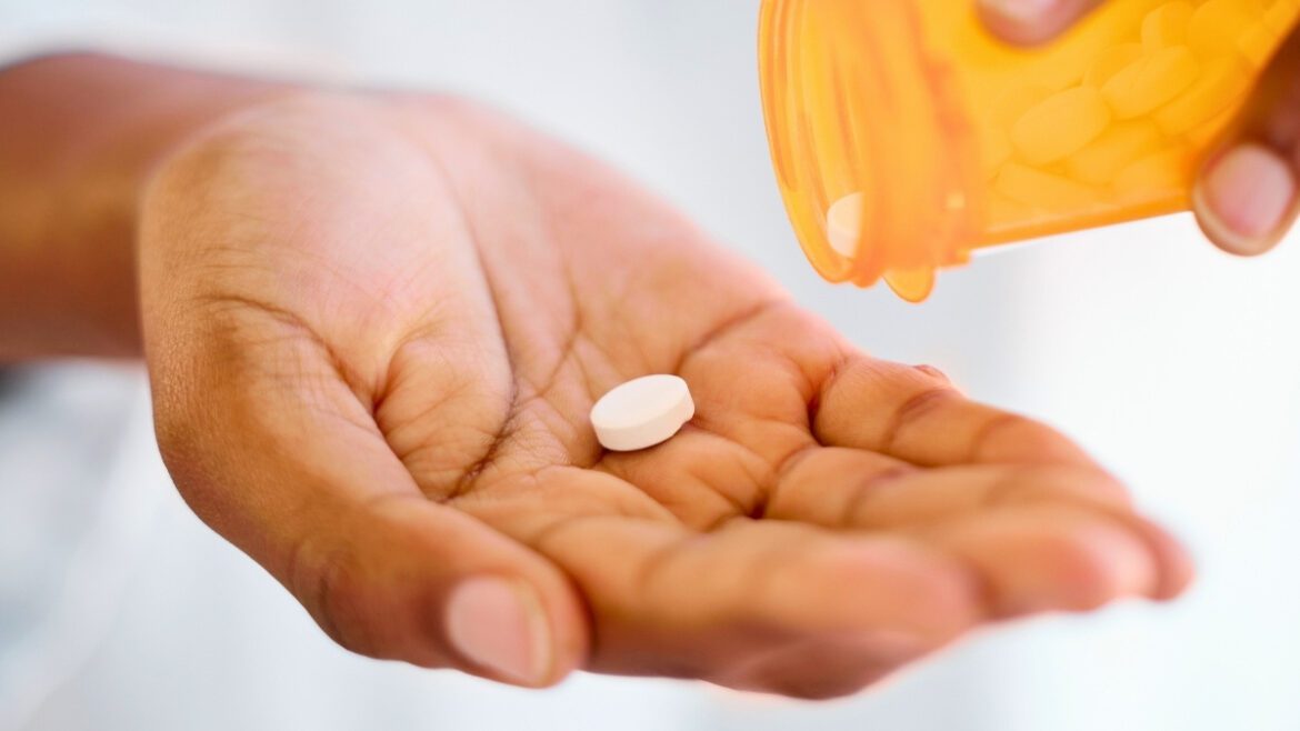 Shot of an unrecognizable person taking tablets at home
