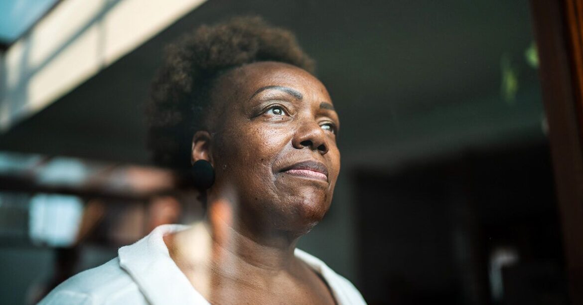 Mature female looking out window 1200 628 facebook 1200x628